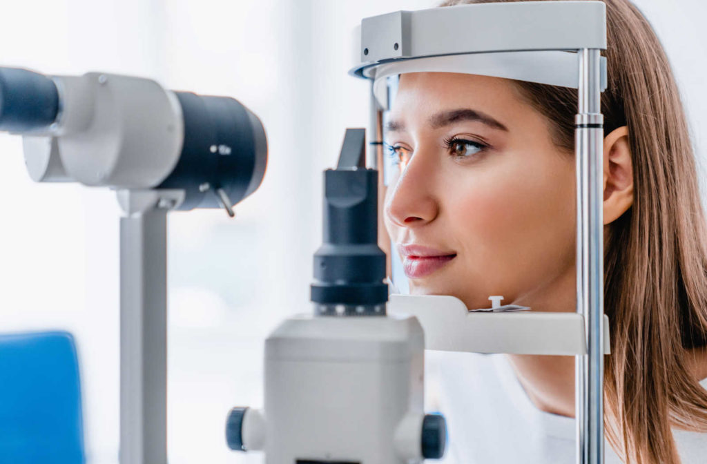 Woman at the optometrist clinic being examined with a slit lamp.