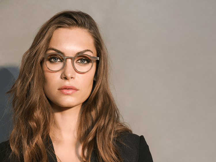 Young female model wearing Lindberg glasses.